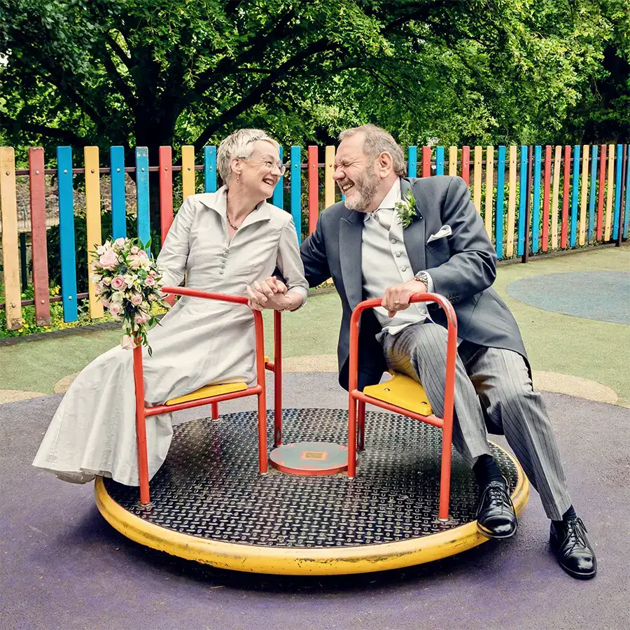 Bride and groom having fun on a playground ride in Worcester Bride and groom having fun on a playground ride in Worcester